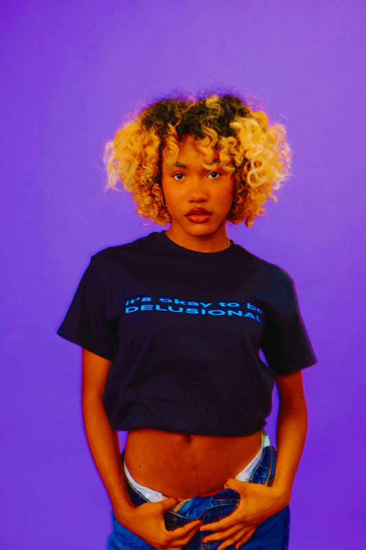 IT'S OKAY TO BE DELUSIONAL TEE [PRE-ORDER]